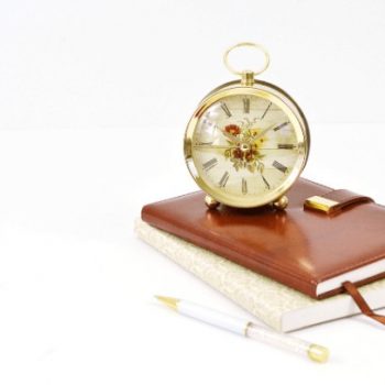 A clock sitting on top of two books